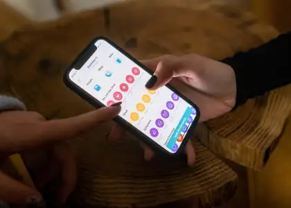 A person holding a phone with a period tracker app