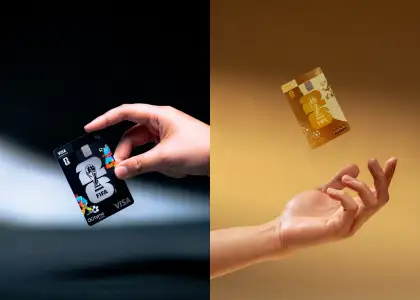 Hands posing with black and gold debit cards
