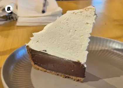 A chocolate pie topped with whipped cream