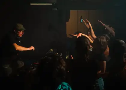 A crowd partying to a DJ
