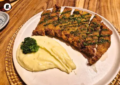 A large breaded veal fillet with mashed potatoes