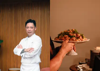 A photo of a chef and a plate of food being served at the table