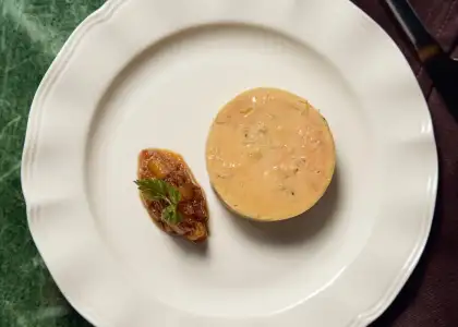 A plate featuring a dessert accompanied by a knife resting beside it.