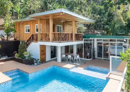 A vacation home with a pool, wooden features