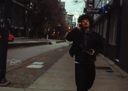 Indian rapper Hanumankind posing on street in America