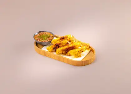 Finger food with a dip with a beige backdrop