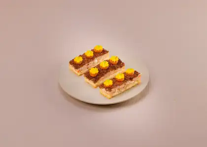 Finger food with shrimp and toast with a beige backdrop