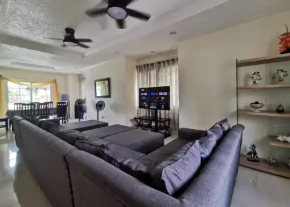 A large grayish blue sofa in a room