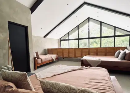 Beds in a bedroom with a large window