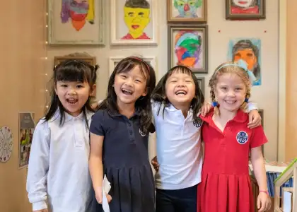 Young students smiling at camera at Hong Kong International School - best Hong Kong International Schools - The Beat Asia