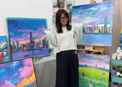 Hong Kong artist Zue Chan posed in her studio with her paintings
