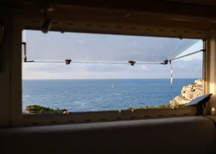 Sea behind window of camper 2022 01 28 09 31 49 utc