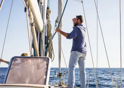 Man stand on a sail boat travel 8 FBGFC7