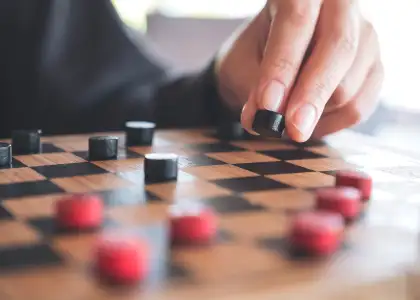 Closeup image of people playing and moving checker DF7 GXJA