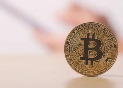 Bitcoin with hand touch on cellphone on the backgr 2 BFE2 ND