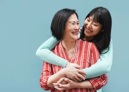 Asian mother and daughter hugging outdoors with bl 2025 02 22 04 38 32 utc