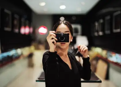 A woman taking a photo LK9 ZBLP