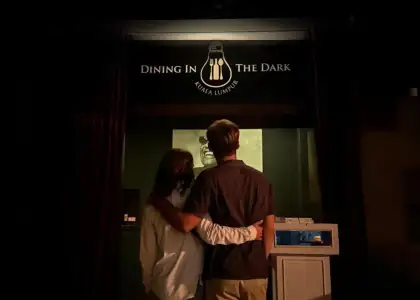 Couple standing at the entrance of Dining in the Dark Kuala Lumpur.