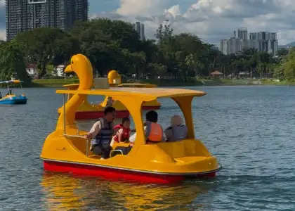 People riding a duck paddle boat at Titiwangsa Lake