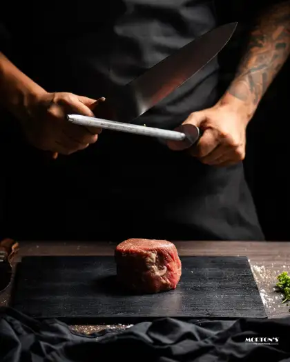 Chef preparing a steak cut