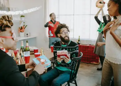 A group of friends enjoying a round of Christmas parlor games.