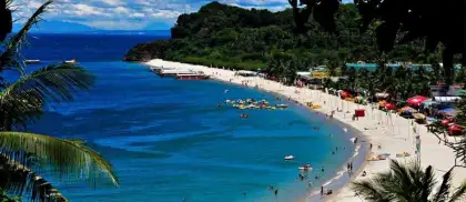 white beach puerto galera with white sand and blue seas and trees