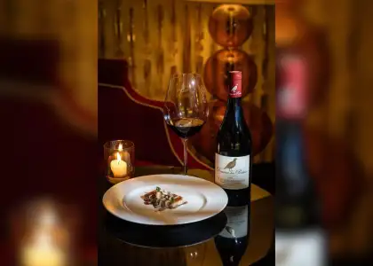 A white plate featuring Honey Glazed Pork Belly