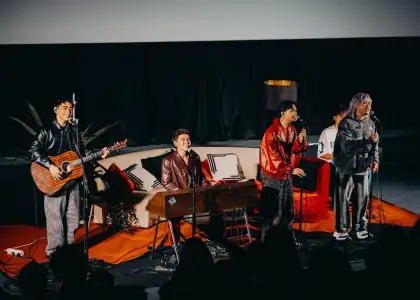 The Juans performs for fans during the listening party for TAWID