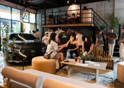 Karrera Showroom cafe people sitting and standing at the cafe area and a car on the side