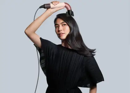 A woman using a Dyson Supersonic r™ Hair Dryer