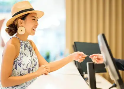 Woman handing over a credit card in a cashier counter