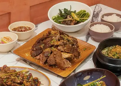 A variety of dishes are arranged on a marble table.