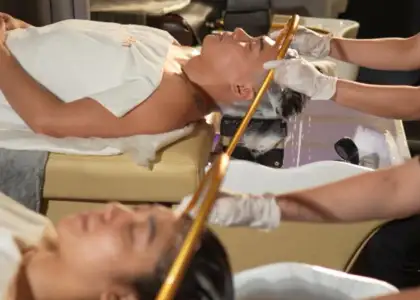 a salon or spa setting with two individuals receiving hair treatments