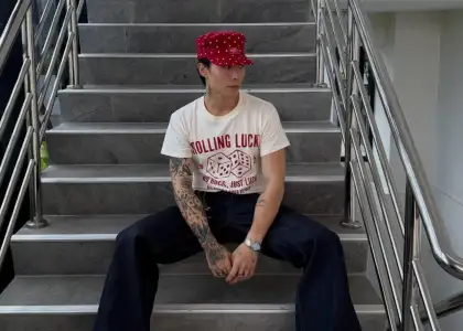 A man in casual clothes sitting on a staircase