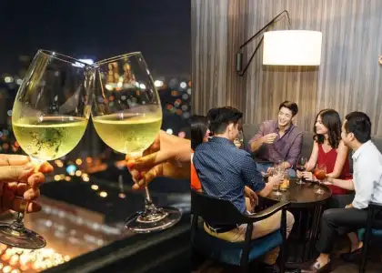 Wine glasses and patrons at Straight Up Rooftop Bar in Seda Vertis North