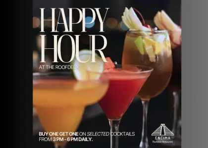 A lively bar scene during happy hour, with patrons enjoying drinks and socializing at the counter.