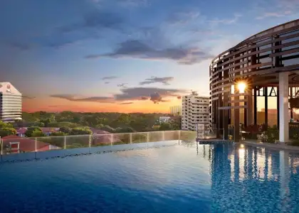 The hotel pool is framed by tall buildings, creating a vibrant urban atmosphere.