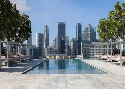 Scenic rooftop pool at Mondrian Singapore Duxton, surrounded by modern architecture and offering panoramic views of the city skyline.